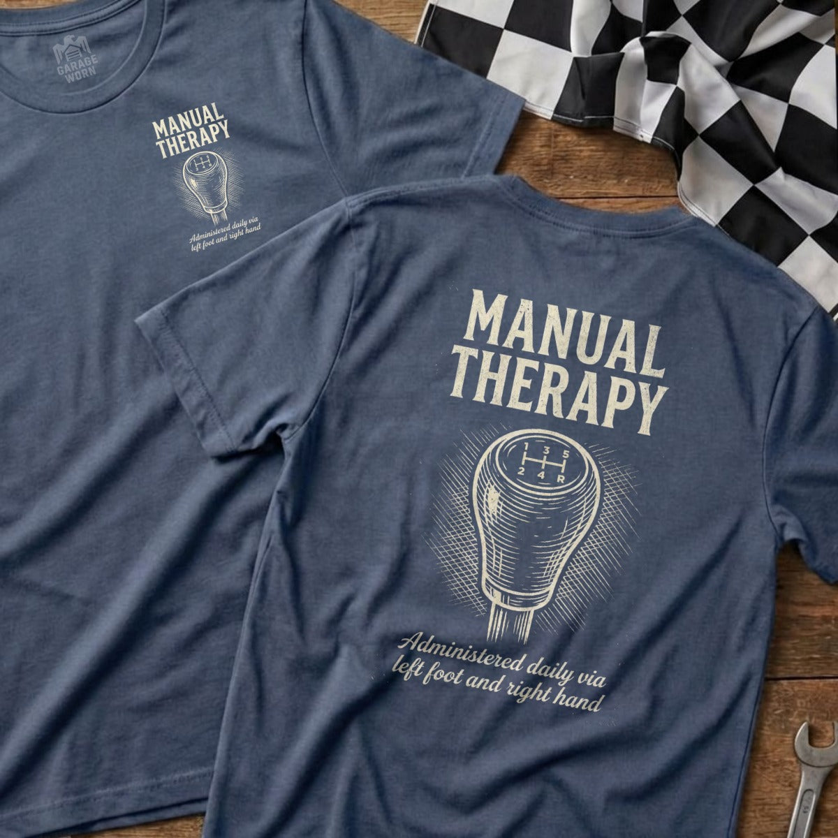 Blue t-shirt with "Manual Therapy" and vintage gear shift graphic.