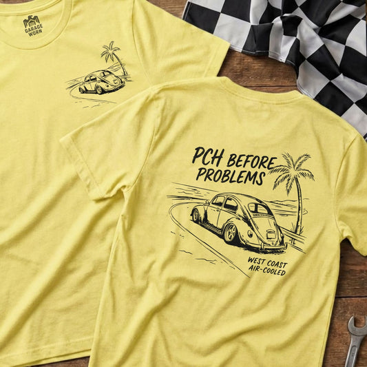 Yellow t-shirt with vintage Volkswagen driving on a road with palm trees.