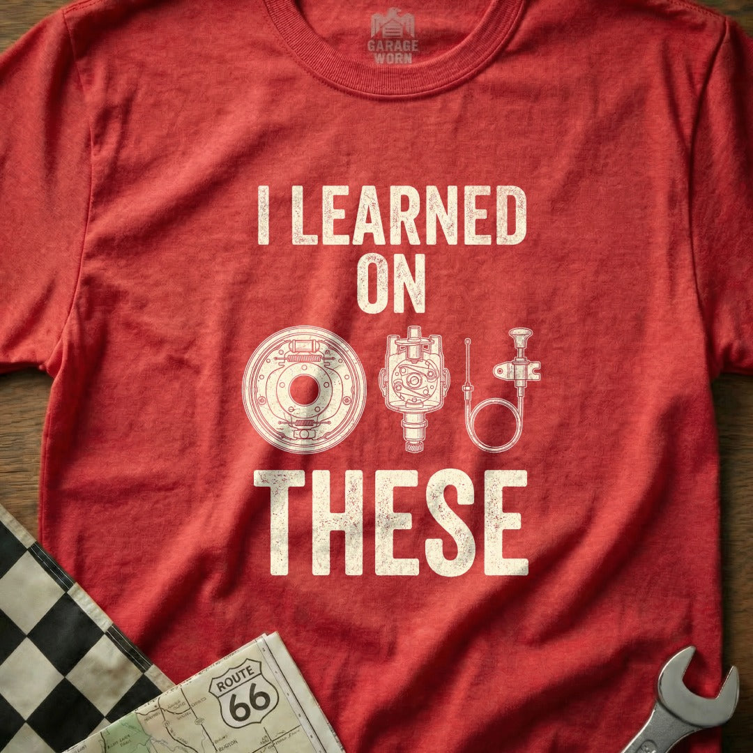 Red t-shirt with white text "I LEARNED THESE" and car part illustrations.