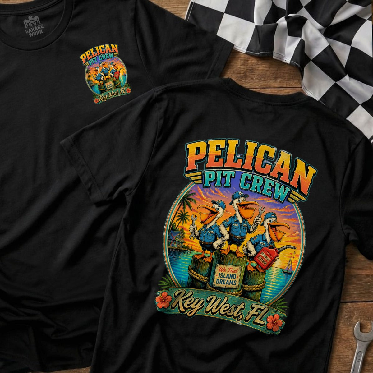 Black t-shirt with "Pelican Pit Crew" graphic of pelicans with tools fueling a boat.