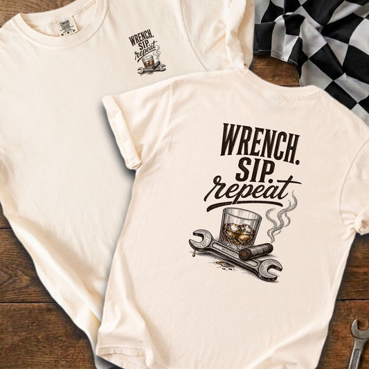 Cream t-shirt with "WRENCH. SIP. repeat." text, glass, cigar, and wrenches graphic.