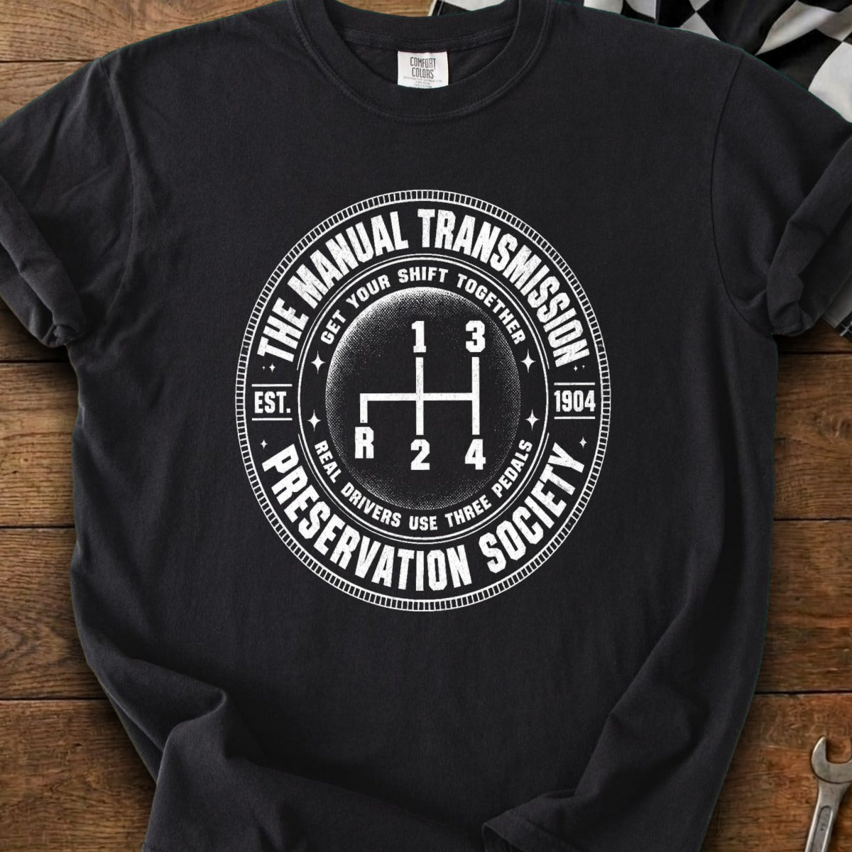 Manual Transmission Preservation Society design with gear shift graphic and text.