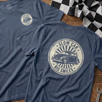 T-shirt with a distressed vintage graphic of a Volkswagen Beetle and text "Slow Car Big Smiles".