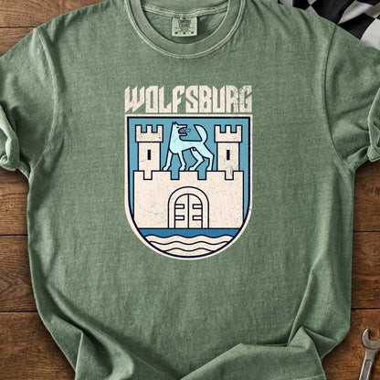 Green t-shirt with "WOLFSBURG" text over a coat of arms featuring a blue wolf.