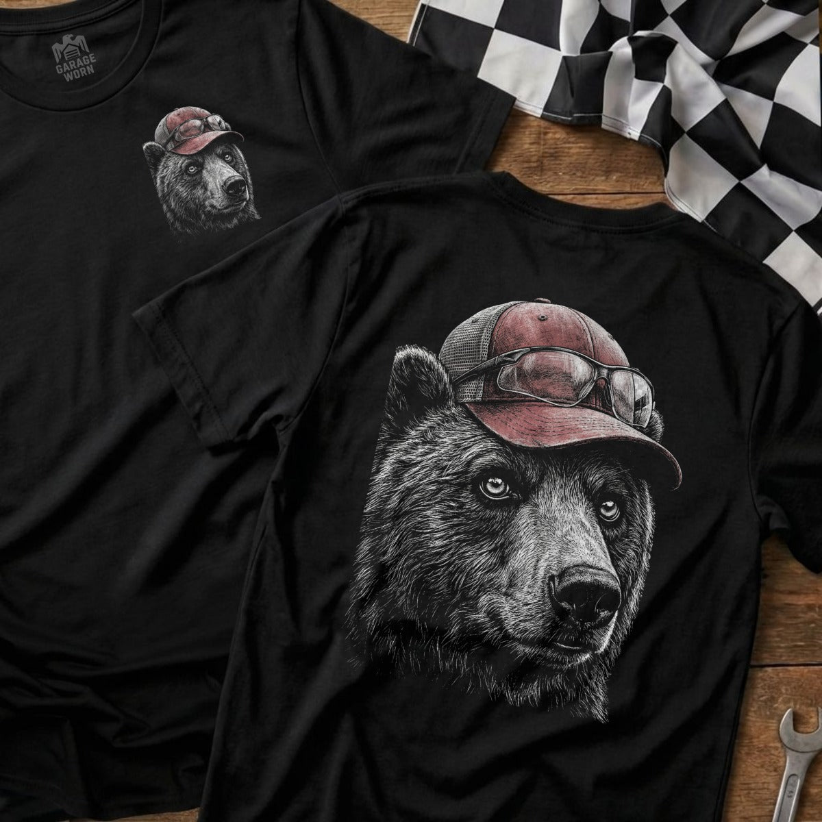 Black t-shirt with a graphic of a bear wearing a red baseball cap and glasses.