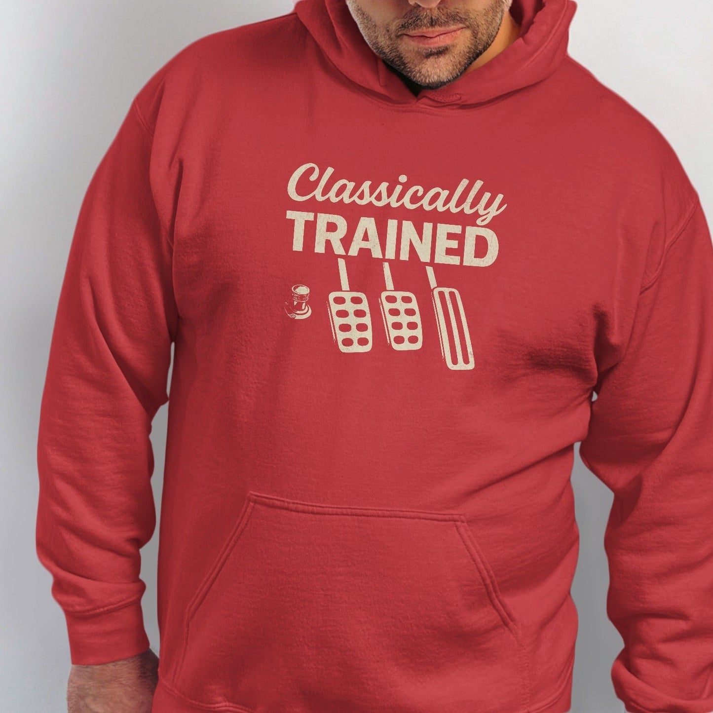 Red hoodie with "Classically TRAINED" text and clutch, brake, and gas pedals.