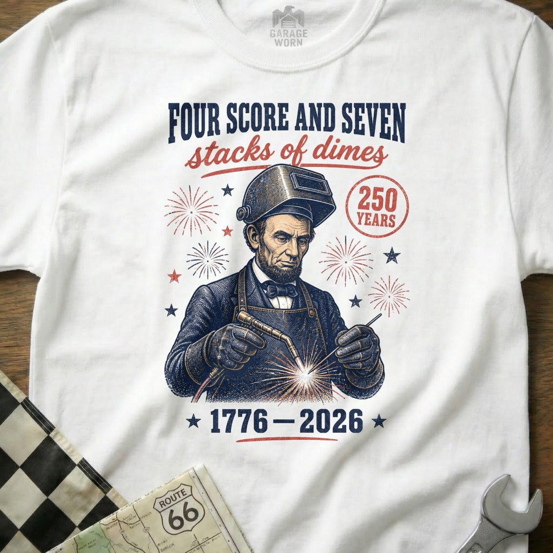 Abraham Lincoln welding with text "Four Score and Seven Stacks of Dimes 1776-2026".
