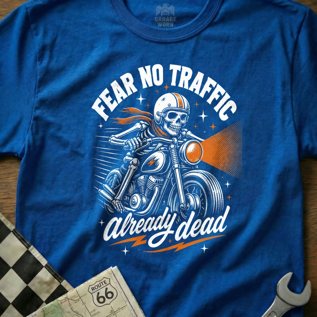 Blue t-shirt graphic of skeleton riding motorcycle with text "FEAR NO TRAFFIC already dead".