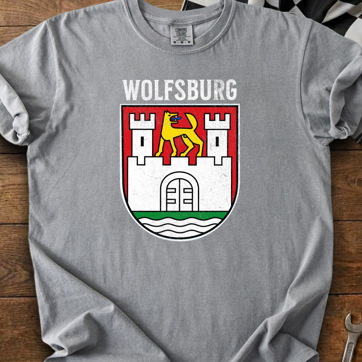 Wolfsburg crest with yellow wolf on white castle wall on red banner.
