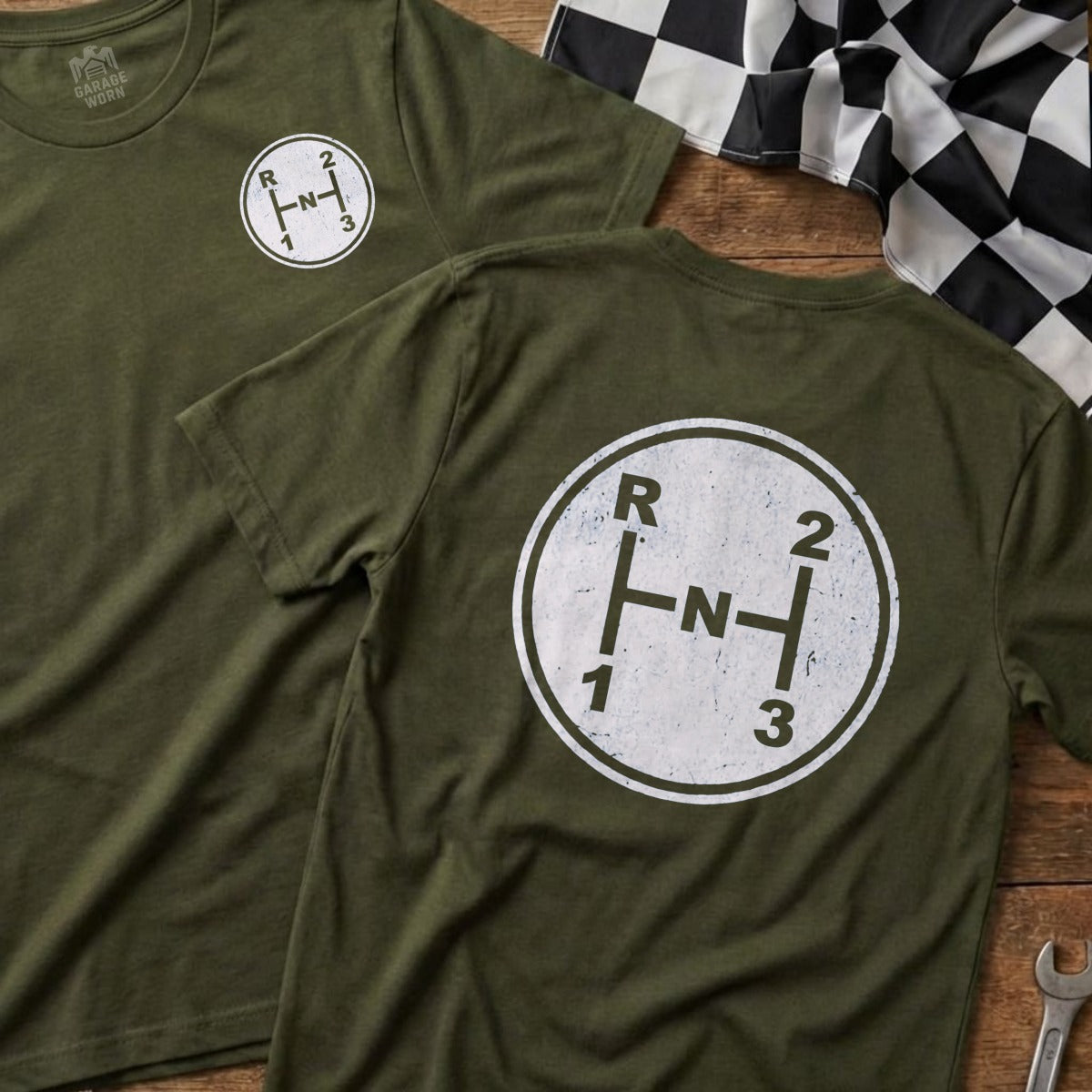 Olive green t-shirts feature a white circular graphic of a manual transmission shift pattern.