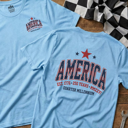 Light blue t-shirt with "America" graphic, EST. 1776 250 YEARS MMXXVI.