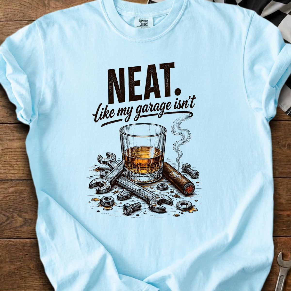 Light blue t-shirt with "NEAT. Like my garage isn't" text and graphic.