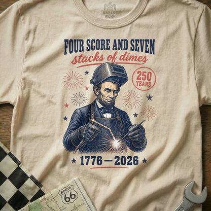 Abraham Lincoln welding with "250 Years 1776-2026" and fireworks.