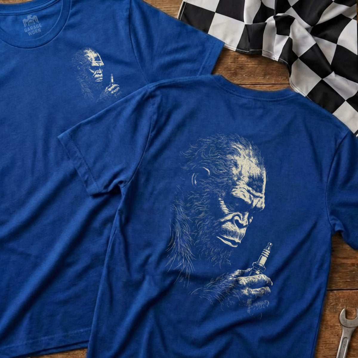 Blue t-shirt with ape holding spark plug on back, and same graphic on front.