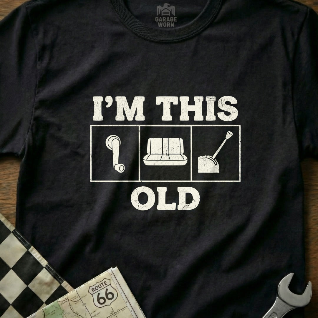 Black t-shirt with white graphic "I'm This Old" and gear shift icons.