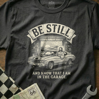 T-shirt with Jesus in a muscle car and "Be Still and Know That I Am In The Garage."