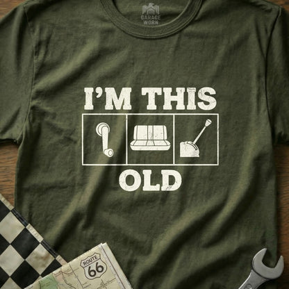 T-shirt with white graphic "I'M THIS OLD" and icons for gear shift, gas pump, and seatbelt.