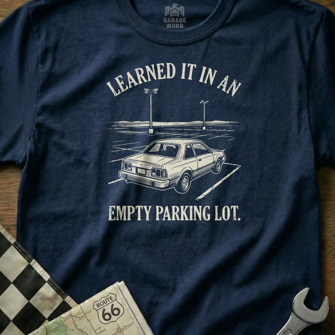 Navy t-shirt with "Learned it in an empty parking lot" and a car graphic.