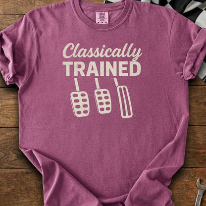 Purple t-shirt with "Classically TRAINED" text and three car pedals graphic.