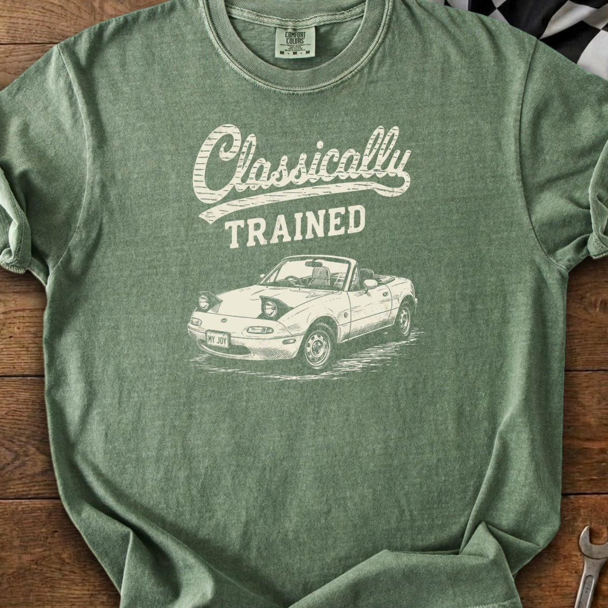 Green t-shirt with "Classically TRAINED" text and a white sketch of a convertible Miata.