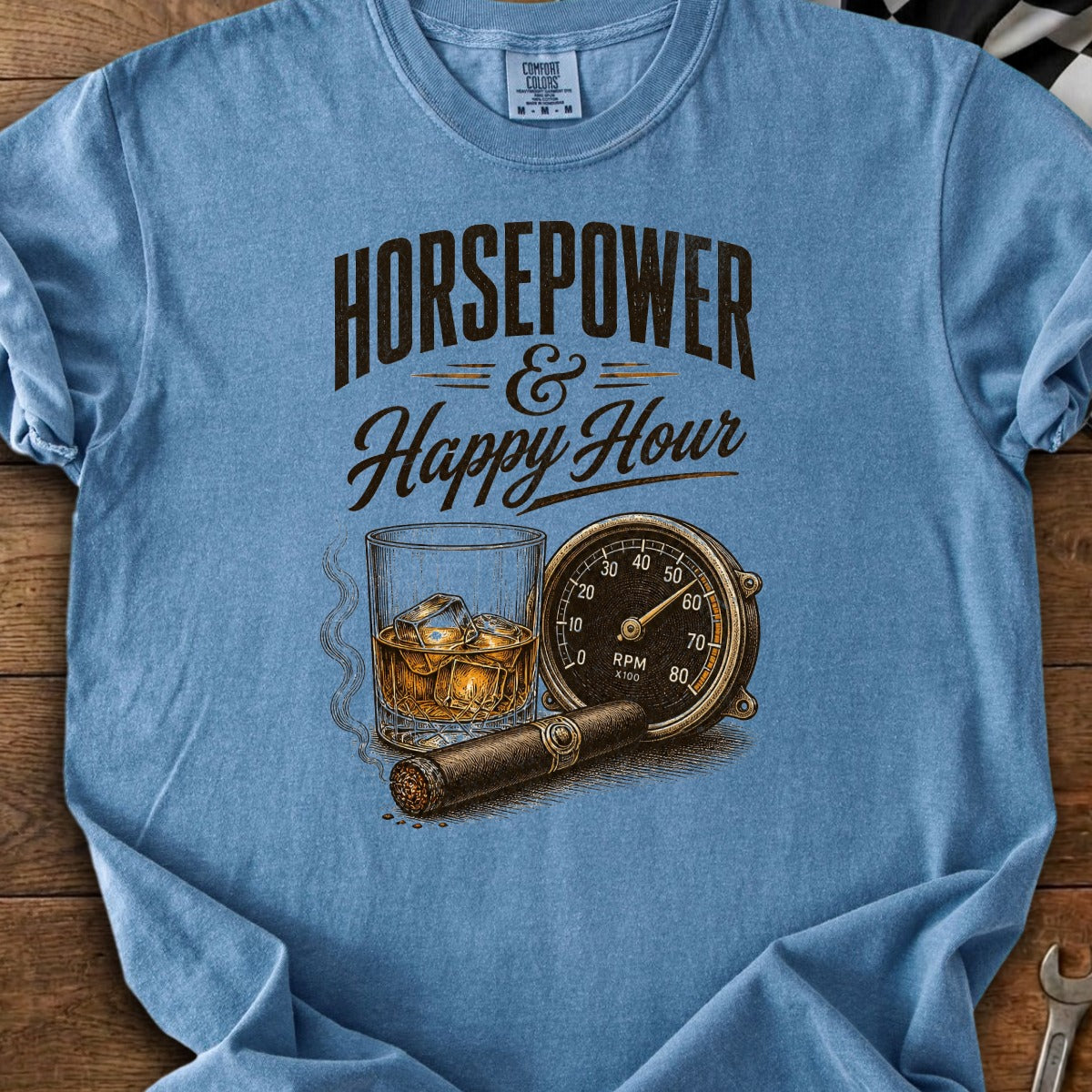 Blue t-shirt graphic with "Horsepower & Happy Hour" text, whiskey, cigar, and tachometer.