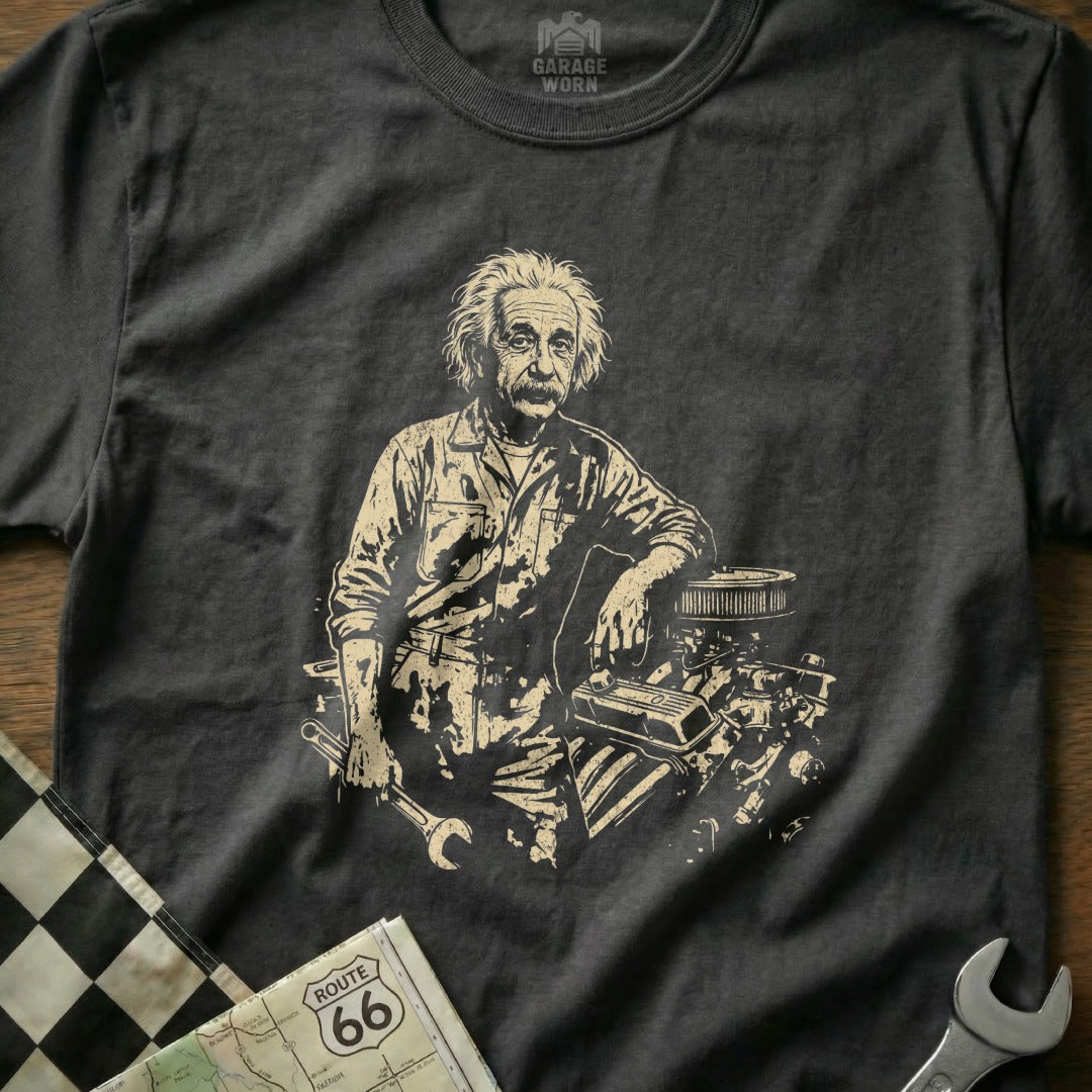 Albert Einstein leaning on an engine with tools.