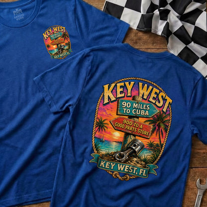 Blue t-shirt with Key West graphic featuring sunset, palm trees, and road signs.