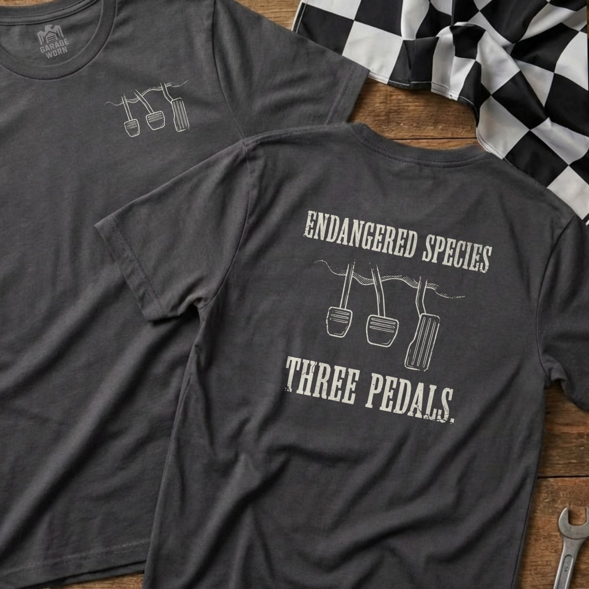 Dark gray t-shirt with "Endangered Species Three Pedals" and pedal graphic.