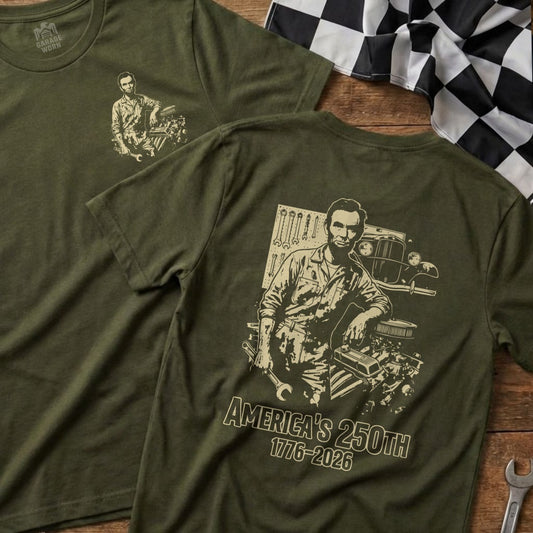 Olive green t-shirt with Abraham Lincoln graphic and "AMERICA'S 250TH 1776-2026" text.