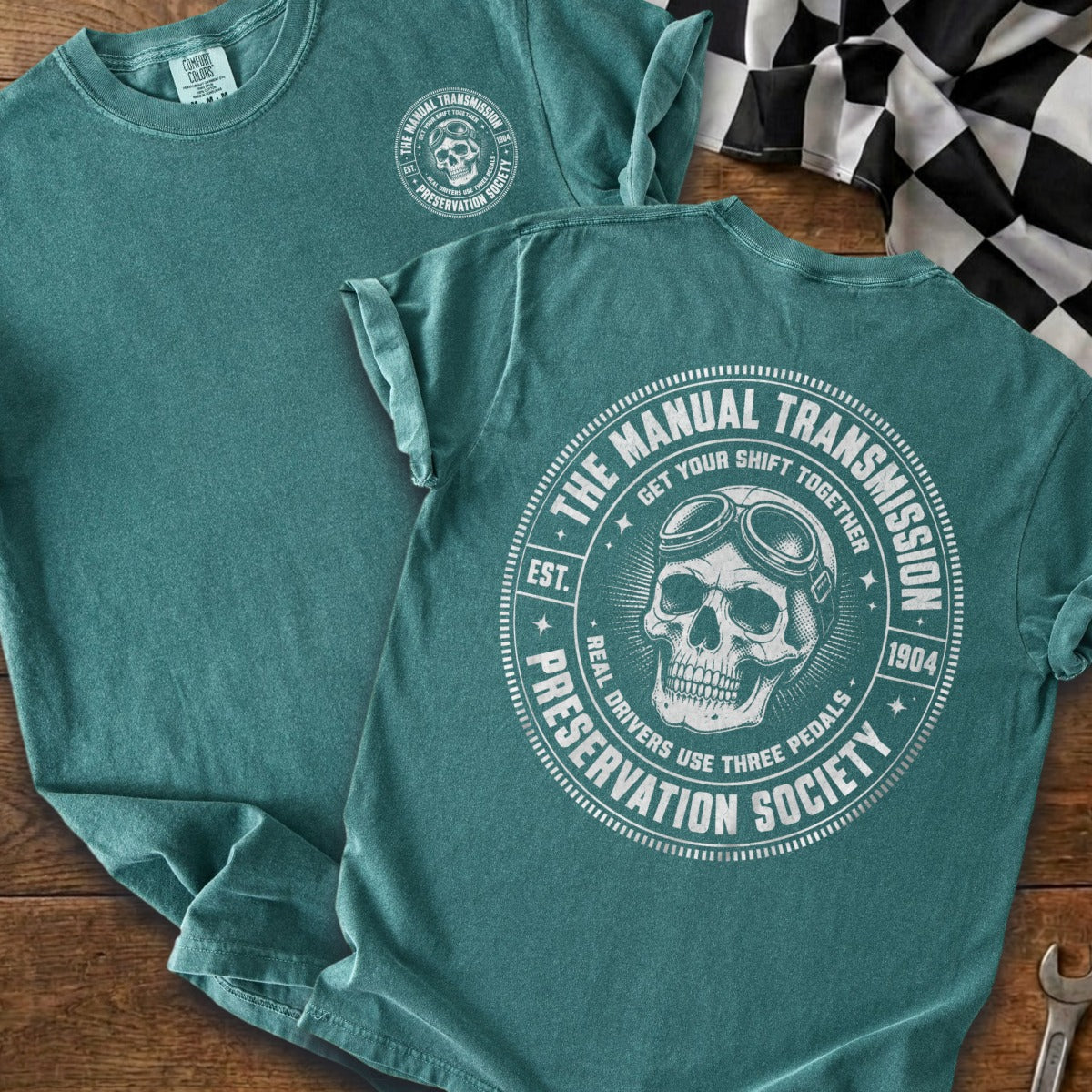 Teal t-shirt with a skull wearing goggles and "Manual Transmission Preservation Society" text.