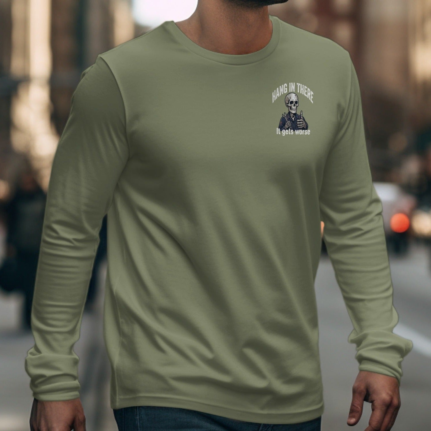 Olive green long sleeve shirt with "Hang in there, it gets worse" skeleton graphic.