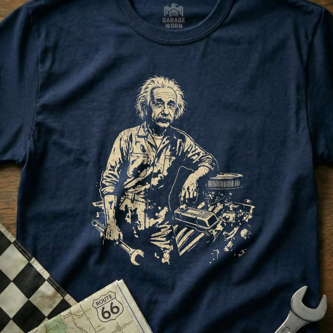 Albert Einstein in mechanic's clothes, leaning on an engine with tools.