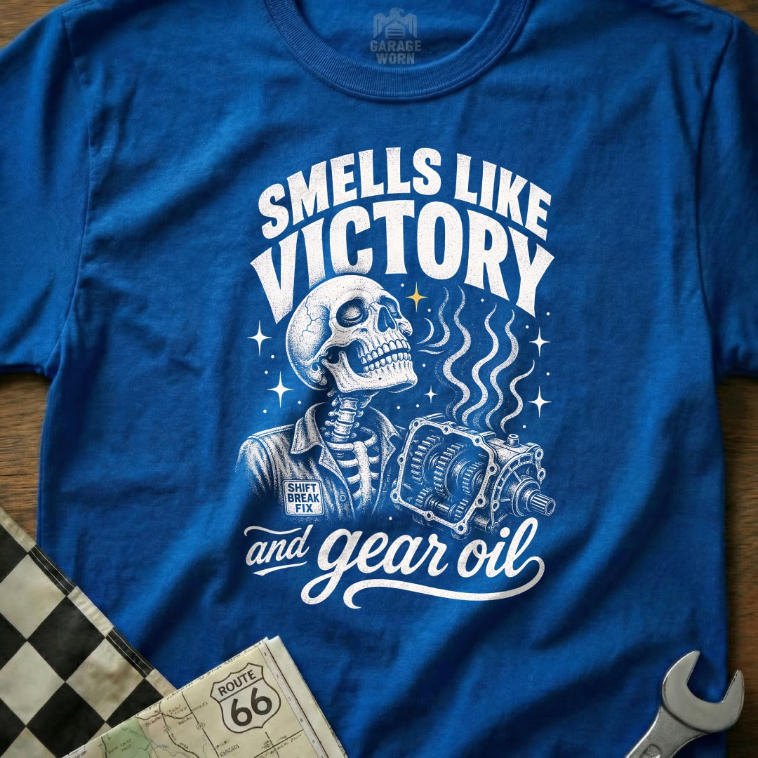 Blue t-shirt with skeleton, gearbox, and "Smells Like Victory and Gear Oil" text.