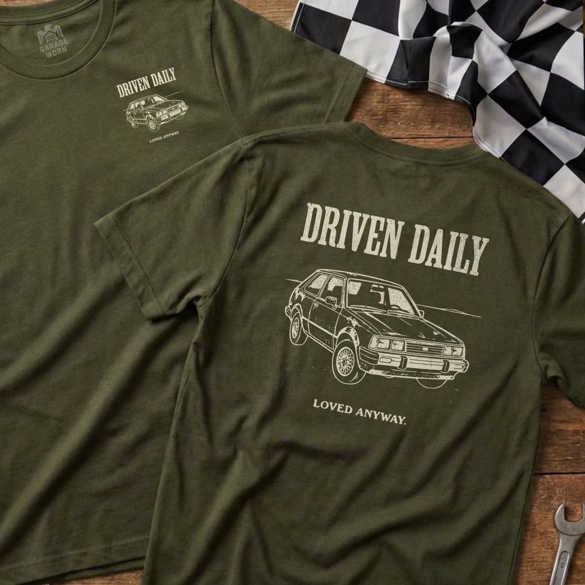 Olive green t-shirt with "Driven Daily" and car graphic on back.