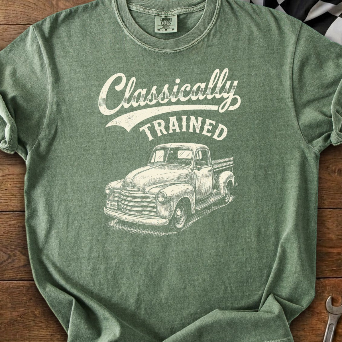 Green t-shirt with white text "Classically TRAINED" and sketched vintage pickup truck.