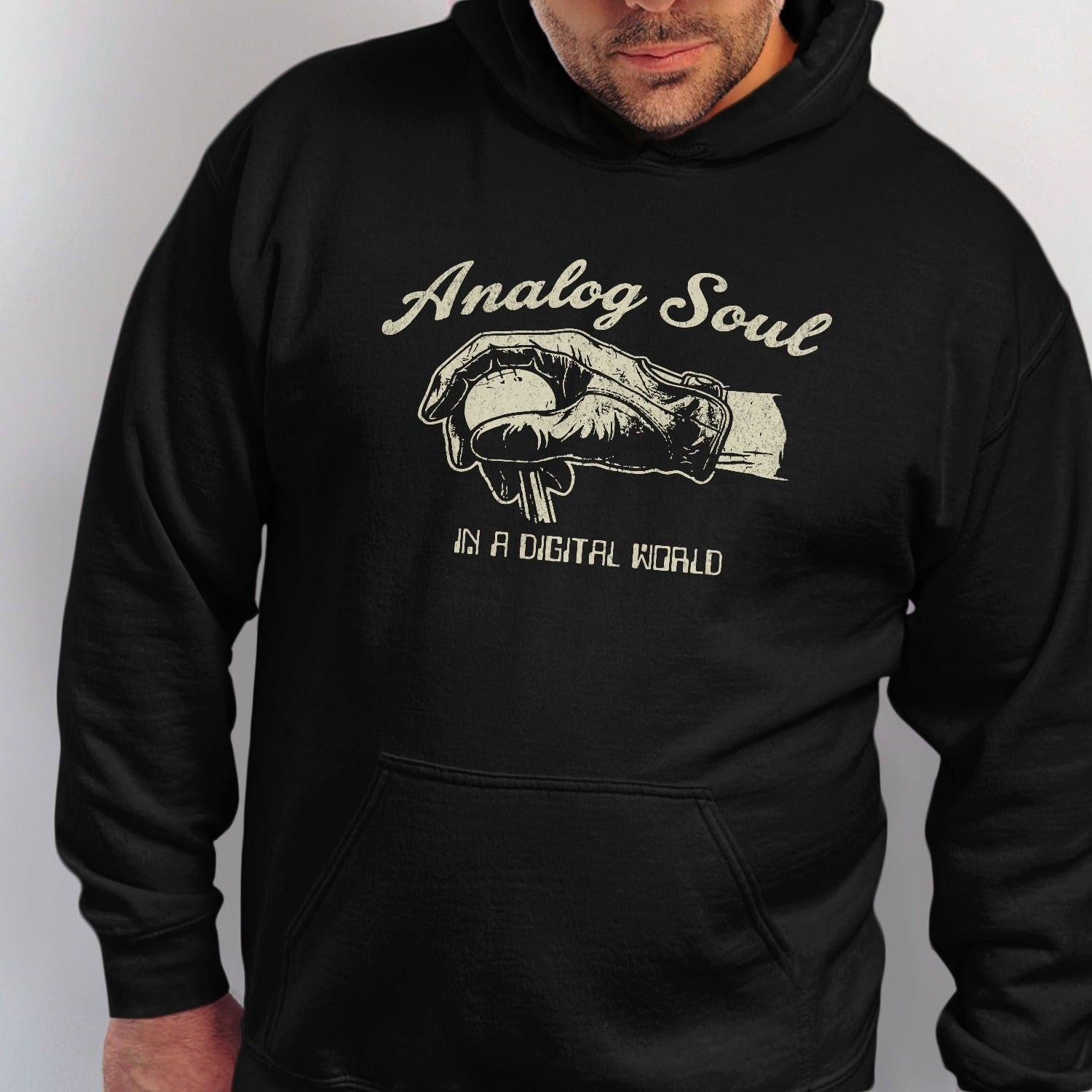 Black hoodie with "Analog Soul in a Digital World" graphic of a gloved hand holding a ball.