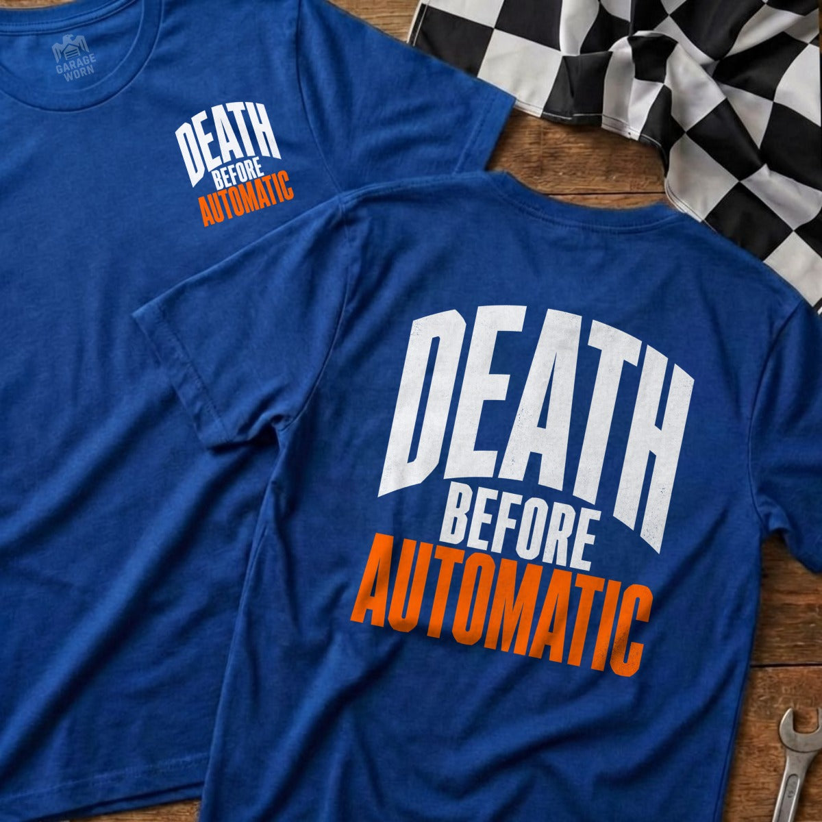 Two blue t-shirts with "DEATH BEFORE AUTOMATIC" printed on them, near a checkered flag.