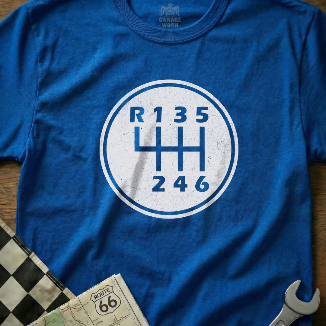 Blue t-shirt with a white gear shift pattern graphic: R135, 246.