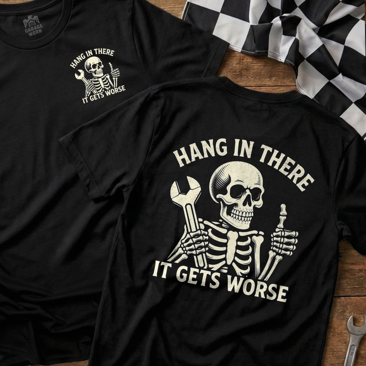 Black t-shirt with skeleton holding wrench and "Hang in there it gets worse" text.