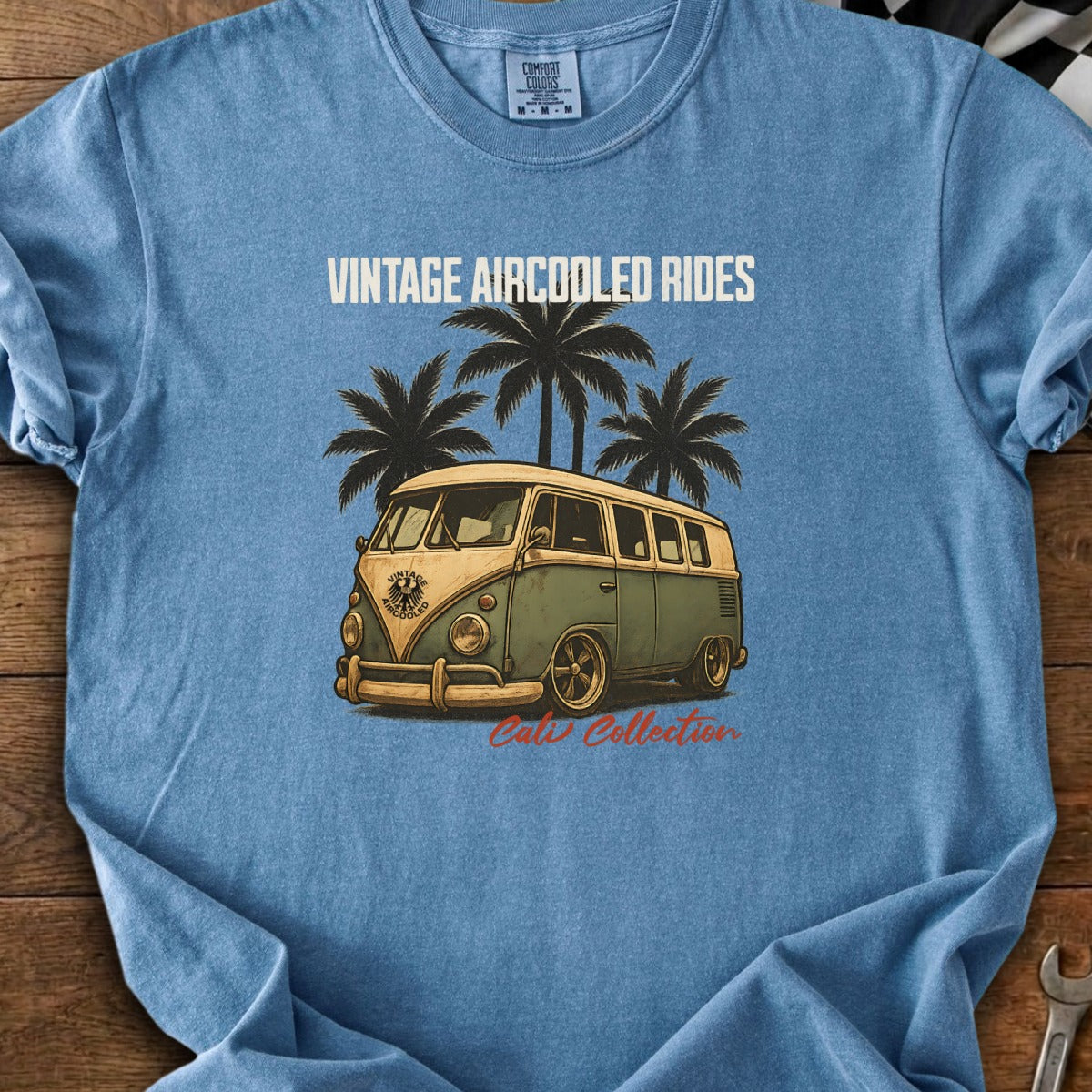 Vintage Aircooled Rides text above a green and tan vintage camper van with palm trees.