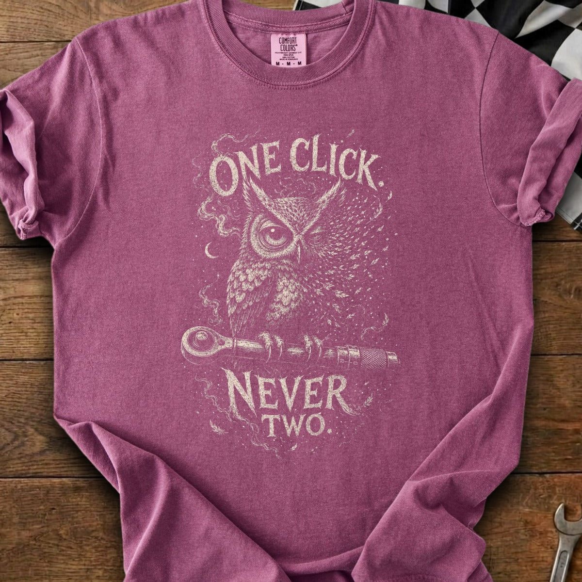 Maroon t-shirt with distressed owl graphic holding a wrench and text "ONE CLICK NEVER TWO".