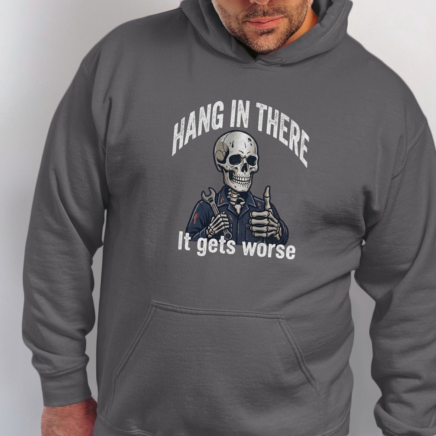 Skeleton wearing overalls and holding wrench with text "Hang in there. It gets worse."