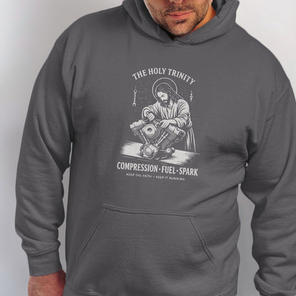 Dark gray hoodie with Jesus working on a motorcycle engine design.