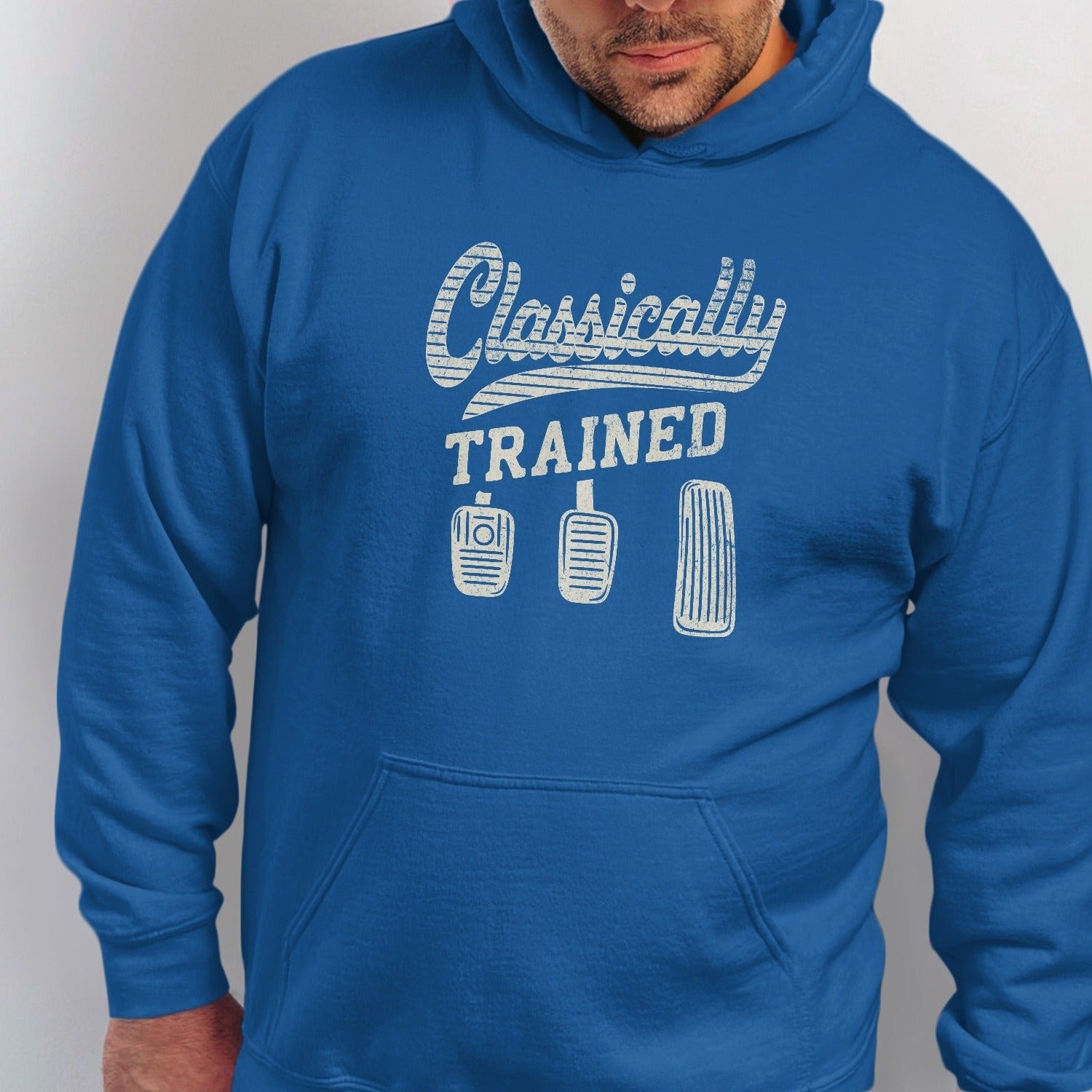 Blue hoodie with "Classically Trained" text and three car pedals graphic.