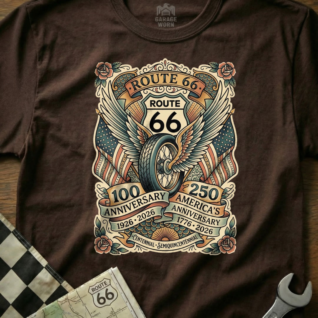 Brown t-shirt featuring Route 66 anniversary graphic with wings, wheel, and flags.