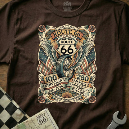 Brown t-shirt featuring Route 66 anniversary graphic with wings, wheel, and flags.
