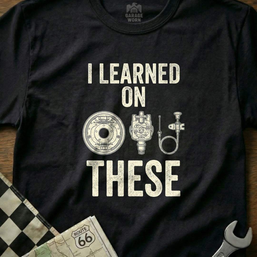 Black t-shirt with text "I LEARNED ON THESE" and vintage car parts.