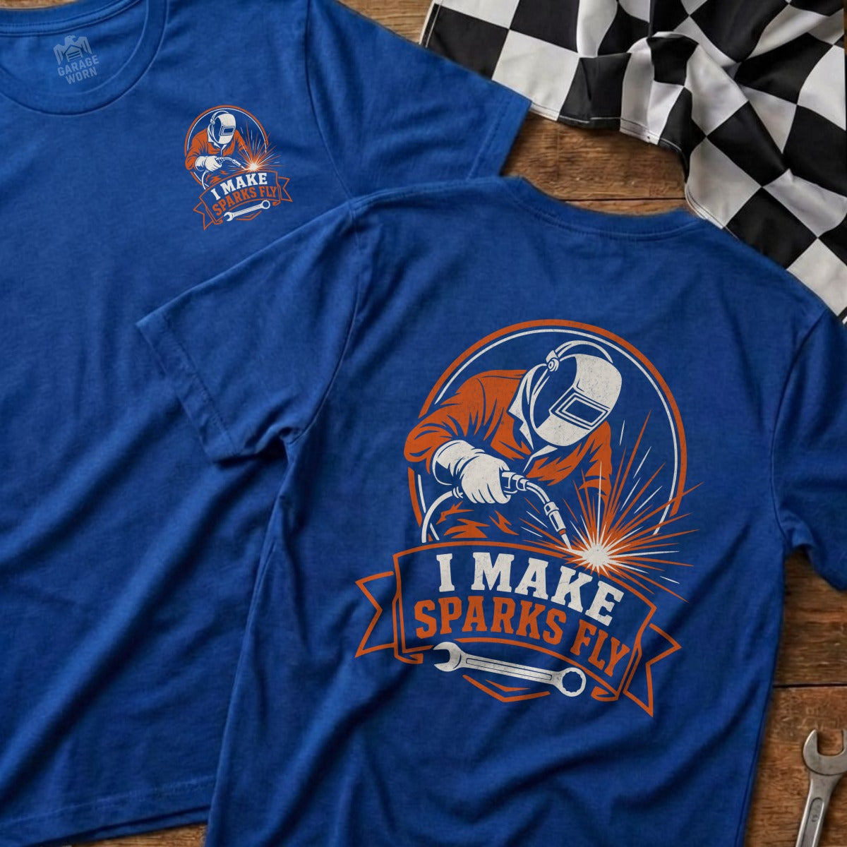 Blue t-shirt with graphic of a welder making sparks and text "I MAKE SPARKS FLY".