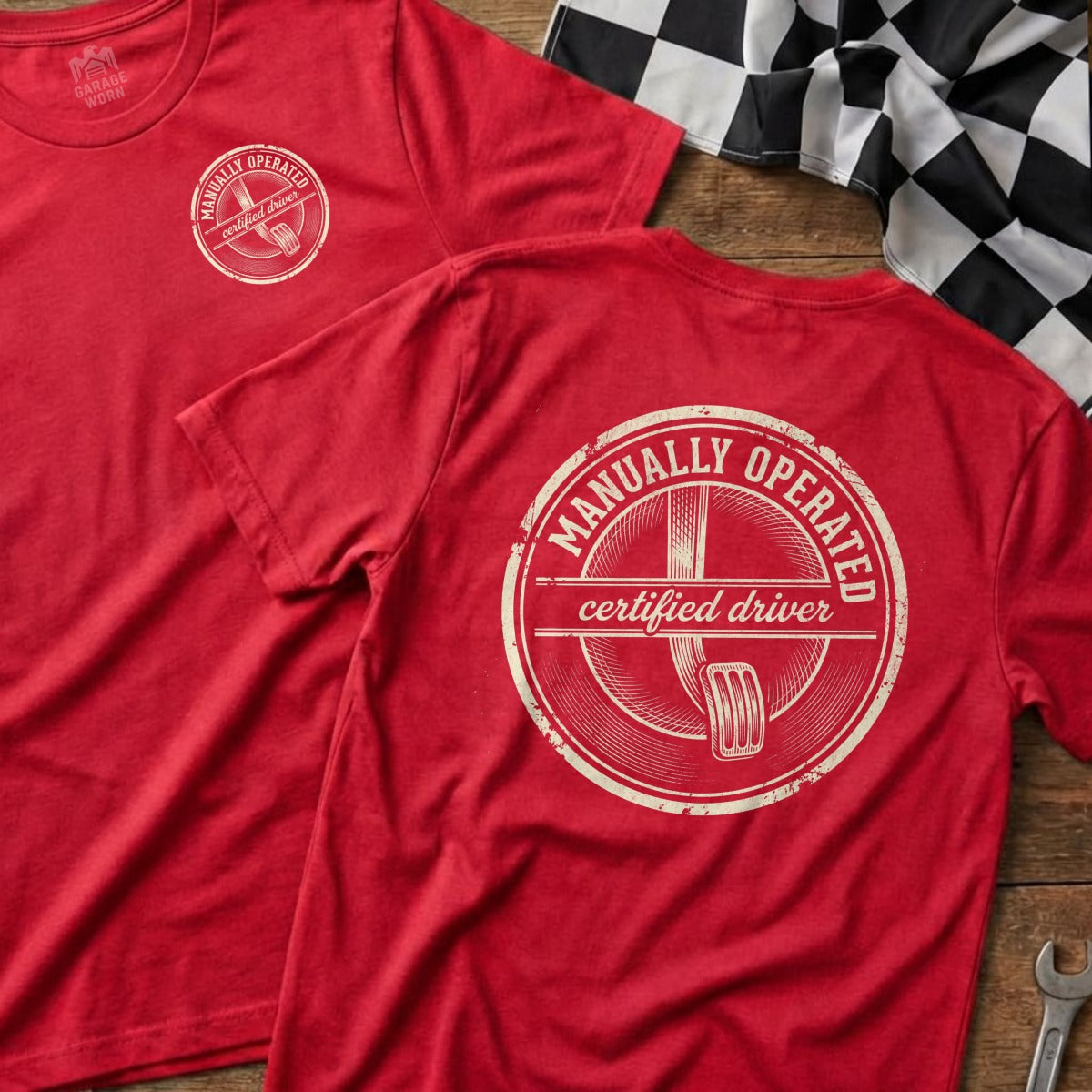 Red t-shirt with "Manually Operated Certified Driver" text and a gear shift graphic.
