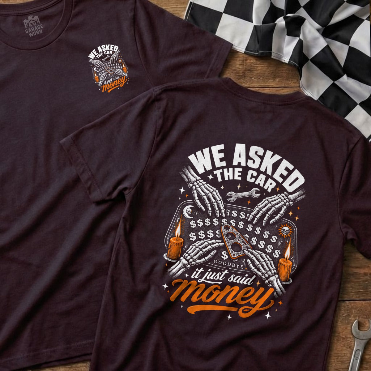T-shirt with skeleton hands on a Ouija board that reads "We Asked The Car, It Just Said Goodbye Money".